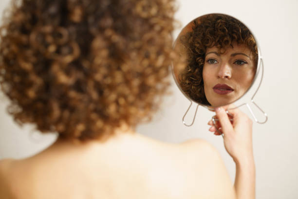 istock Charming woman with makeup looking reflection in mirror 1594481081