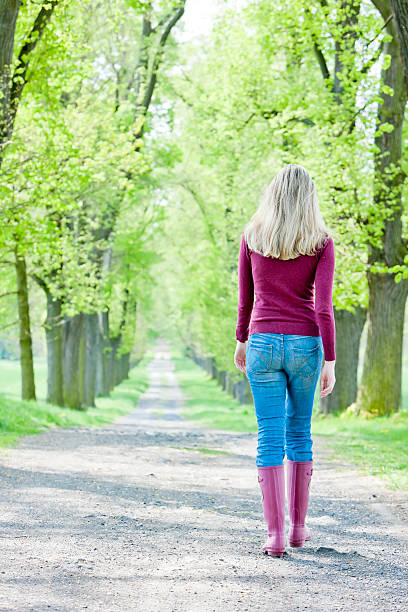 istock woman in spring alley 159452440