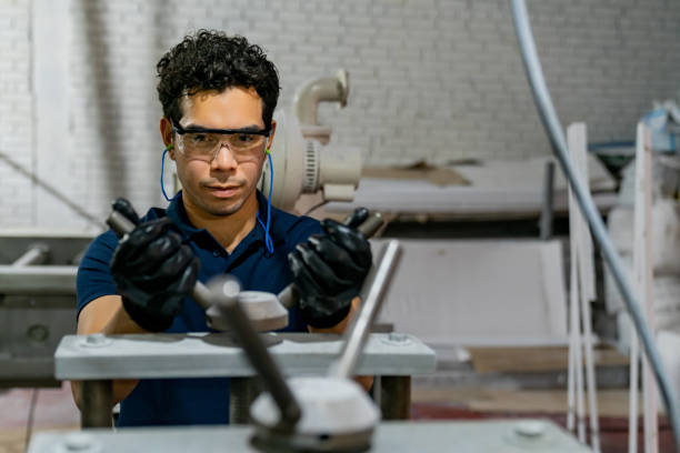 istock Blue-collar worker working at a wood factory 1594542475