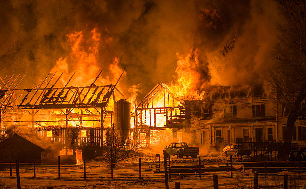 Blurred background. small wooden cottage on fire at night