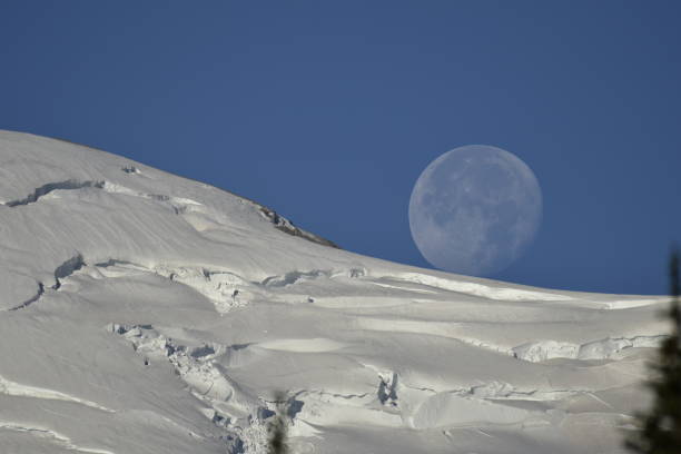 istock Moon Resting Atop Mount Rainier 1594576605