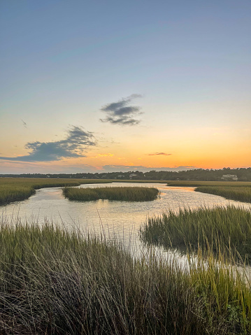 Sunset and golden hour light over The Salt water marsh and the sound behind Pawley's Island, South Carolina