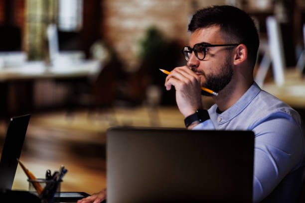 istock Young man thinking out loud when working at his desk 1594618987