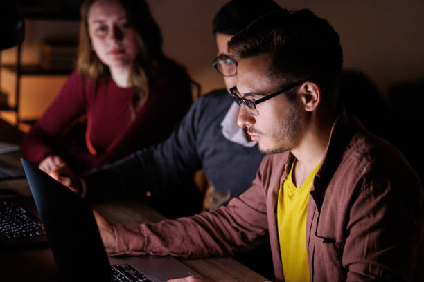 istock Small group of colleagues collaborating on a project late at night 1594626297