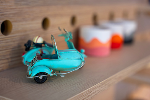 toy motorcycle and handmade ceramic cups on the shelf