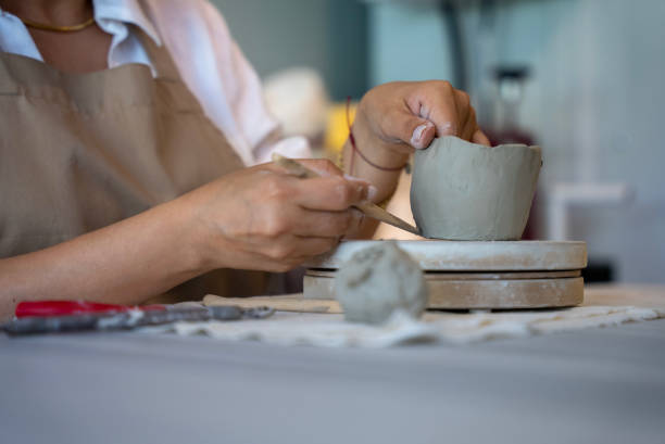 istock process of shaping ceramic clay into a mug at handmade ceramic workshop, shaping ceramics in the ceramics workshop 1594648508