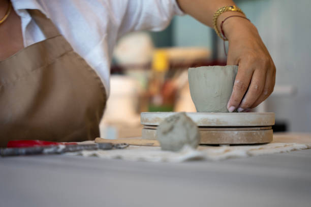 istock process of shaping ceramic clay into a mug at handmade ceramic workshop, shaping ceramics in the ceramics workshop 1594649023