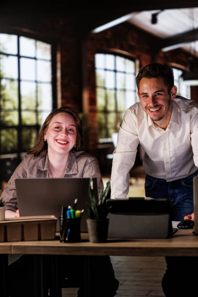istock Business people joyfully smiling at camera when co-working on a mutual project 1594658035