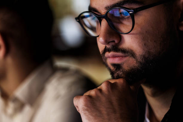 istock Focused young man using laptop when working late at the office 1594658047