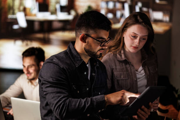 istock Two colleagues discussing data they are analyzing off of digital tablet 1594659073