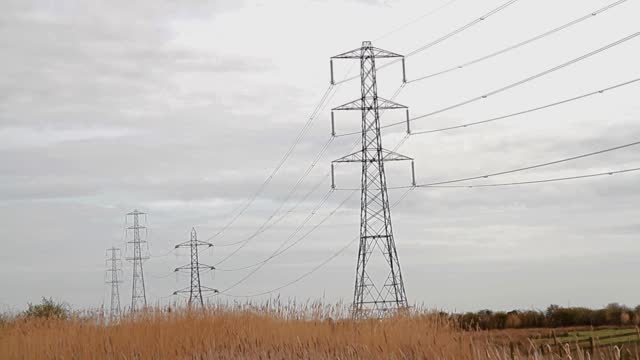 Video, Line of electrical pylons in countryside.