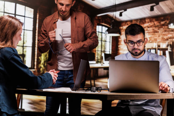 istock Having coffee and discussing project ideas when staying late at the office 1594663764
