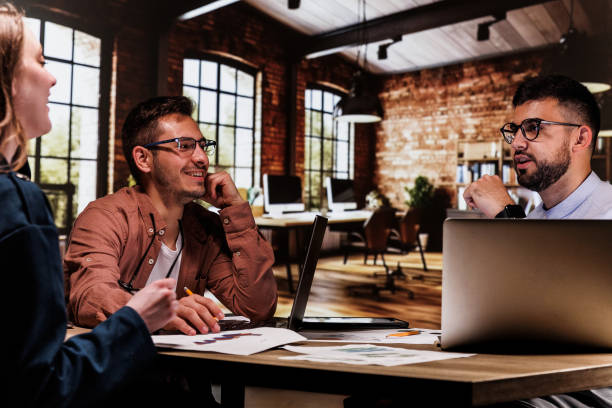 istock Entrepreneurs sharing their input for a project they are co-working on 1594663774