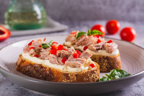 istock Open sandwiches with canned tuna, pepper and basil on cream cheese on a plate 1594714918