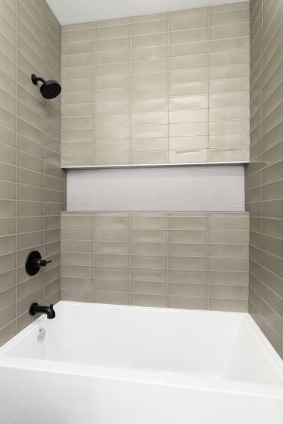 istock A shower with brown subway tiles and black faucet. 1594716991