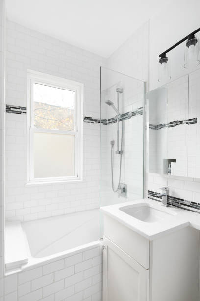 istock A bathroom with white subway tile walls and cabinet. 1594717012