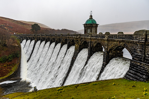 Water overflows the Craig Goch dam in the Elan Valley, Powys, Mid Wales