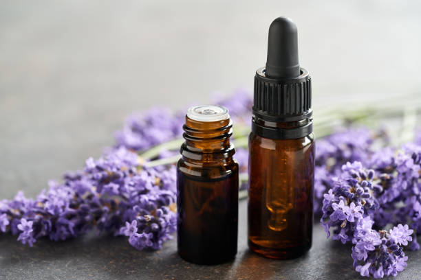 istock Brown essential oil bottles with fresh blooming lavender 1594737680