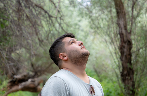 Young man breathing oxygen in nature
