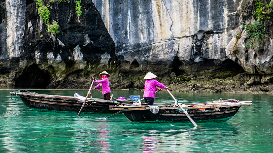 Ha long Bay and its floating villages, several images of a boat ride with the boatwomen dressed in typical Vietnamese clothing, and general landscapes