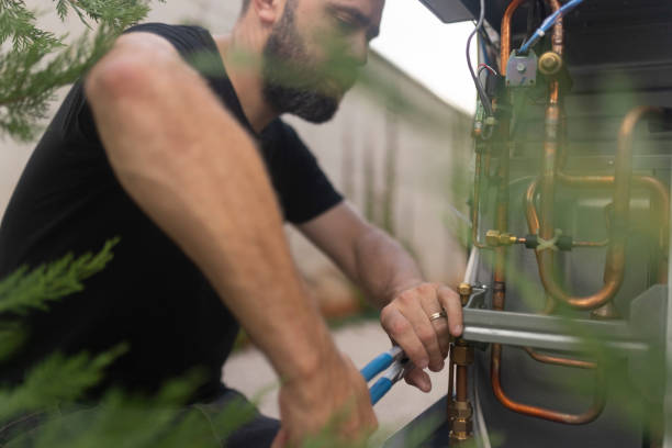 istock Concentrated technician installs a heat pump, which is extremely environmentally friendly 1594764603