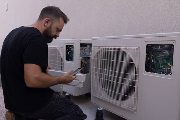 istock Bearded man installs a heat pump, which is extremely environmentally friendly 1594764613