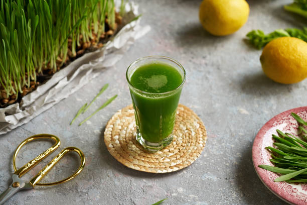 istock Fresh green barley grass juice in a glass cup 1594777815