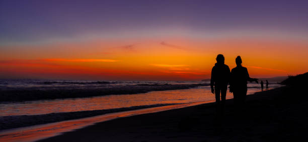 istock Couple Walking on the Beach 1594824551