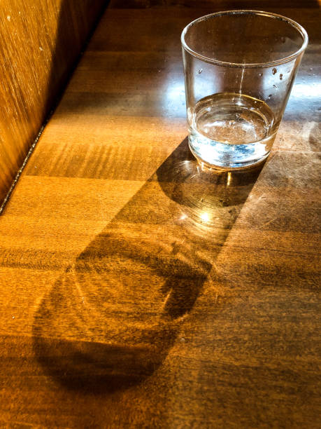Glass of water on table in fancy restaurant with condensation