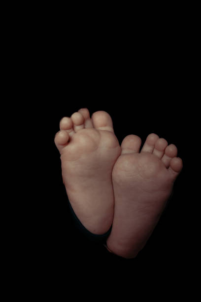 Children's feet on a black background