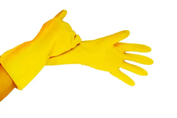 female hands in yellow working rubber gloves for cleaning and cleanliness of the room, photo close up in studio isolated on white background