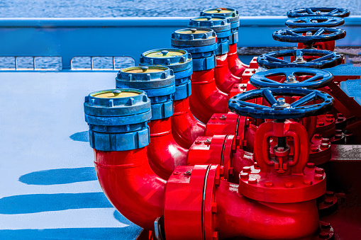 bright background Five red fire hydrants on a fire line on a ship. fire safety safety of life concept.