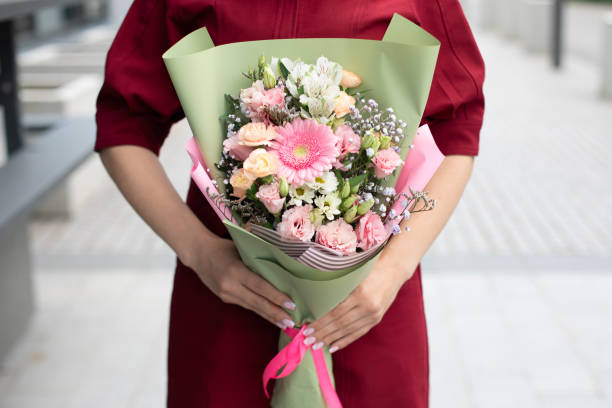 istock Female hands holding beautiful bouquet 1594970988