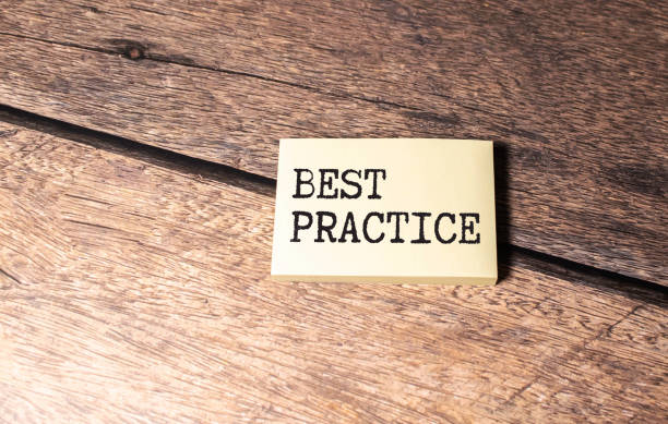 istock Best practice on a notepad on a blue-yellow background, a cup of coffee and a pen. 1595019960