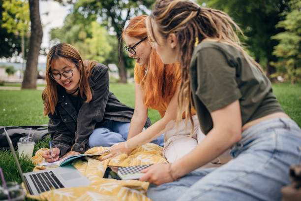 istock Female friends in park 1595021028