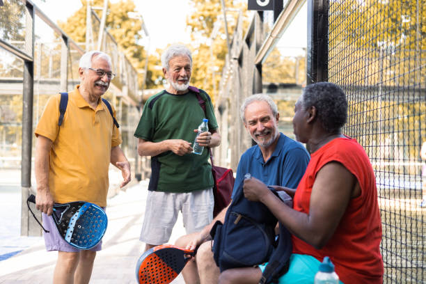 istock Four cheerful seniors preparing for their weekend Paddle Tennis competition 1595071077
