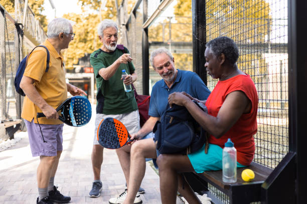 istock Four cheerful seniors preparing for their weekend Paddle Tennis game 1595071085