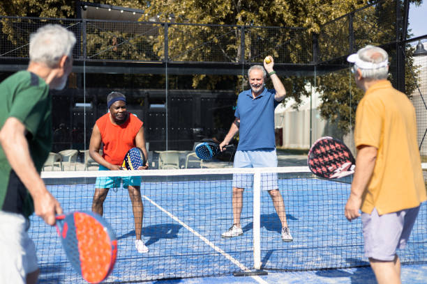 istock Senior friends playing Paddle Tennis for the weekend 1595072155