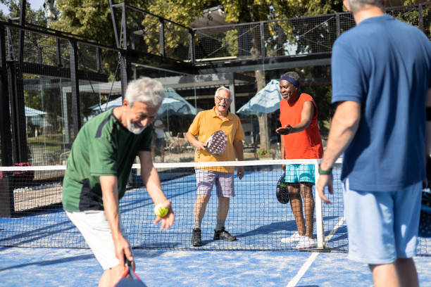 istock Senior friends having fun playing Paddle Tennis 1595073194
