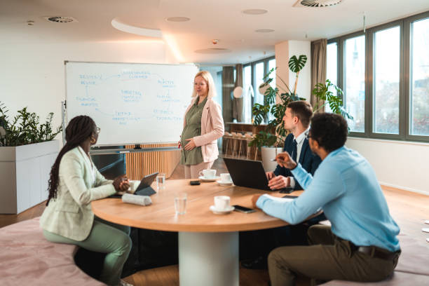istock CEO Discusses Innovative Marketing Ideas with Multiracial Employees 1595125687