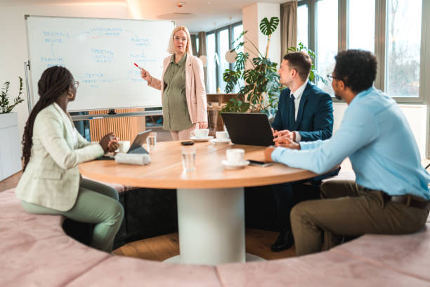 istock Empowered Female Leader Guides Mixed Race Group 1595125689