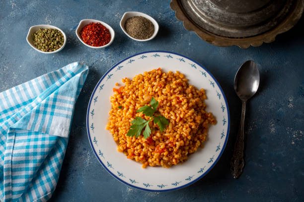 istock Traditional turkish bulgur pilaf with tomato sause in plate (Turkish name; meyhane pilavi) 1595126206