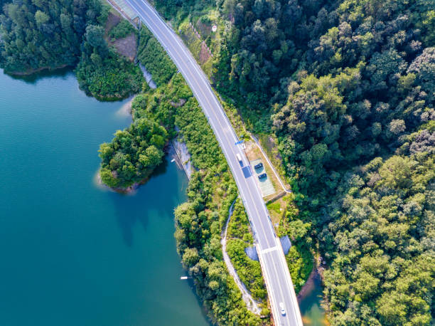 istock Large reservoir and road bridge overlooking the mountains 1595127272
