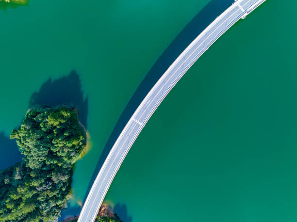 istock Large reservoir and road bridge overlooking the mountains 1595128903