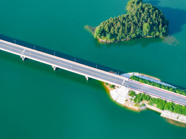 istock Large reservoir and road bridge overlooking the mountains 1595130991