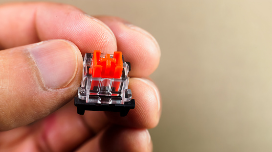 Switches of a mechanical keyboard on a man's hand. Macro photo. Close-up.