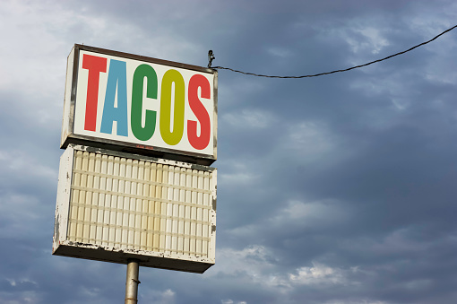 Old run-down tacos sign
