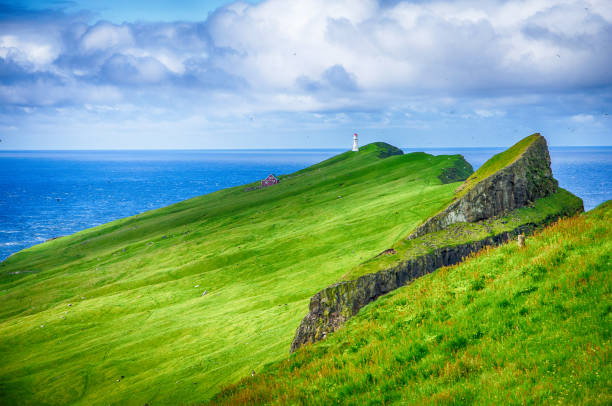 Iconic red and white lighthouse on Mykines Island