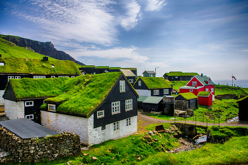 Traditional village with colorful houses and grass on the roofs. Mykines island, Faroe Islands