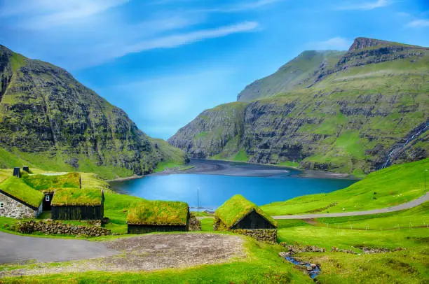 Photo of Village at saksun with grass on the roof with lagoon in Faroe Island